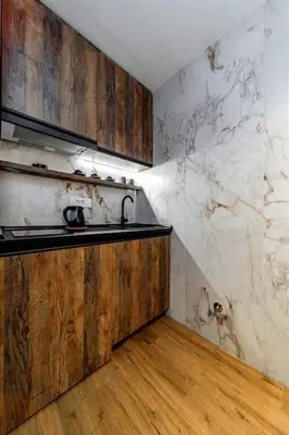 a kitchen with a sink and a marble wall at Dark Nest 2 Belgrade Apartments in Belgrade