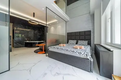 a bedroom with a bed in the middle of a room at Zebrano Spa in Novi Beograd