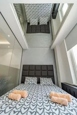 a bedroom with a large bed with two pillows at Zebrano Spa in Novi Beograd