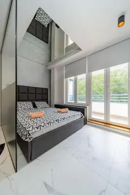 a bedroom with a bed and a large window at Zebrano Spa in Novi Beograd