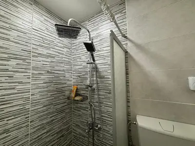 a shower in a bathroom with a glass door at Apartment DD in Belgrade