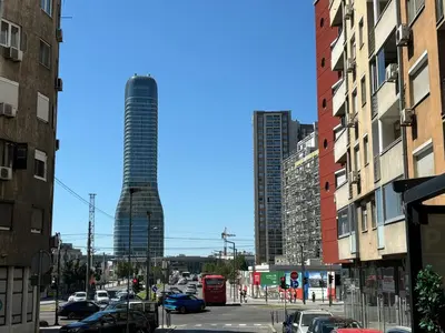a city street with a tall building in the background at Apartment DD in Belgrade