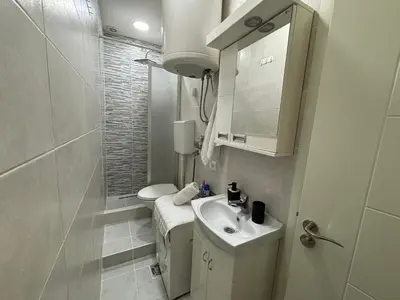 a small bathroom with a sink and a toilet at Apartment DD in Belgrade
