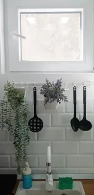 a kitchen counter with three utensils and a window at Cradle of Love in Belgrade