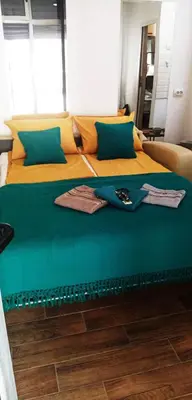 a bedroom with two beds with yellow and blue at Cradle of Love in Belgrade