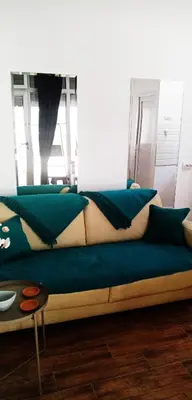 a couch with blue pillows on it in a room at Cradle of Love in Belgrade