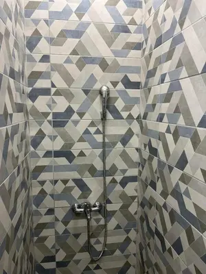 a shower in a bathroom with a tiled wall at MUNJA Apartman in Belgrade