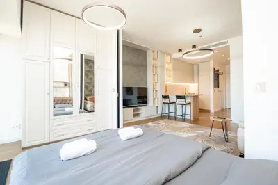 a bedroom with a large bed with two white towels at West Kula 14 in Belgrade