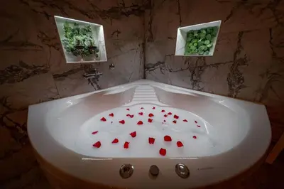 a white bath tub with red hearts in it at Lisa Zemun Spa Apartment in Zemun