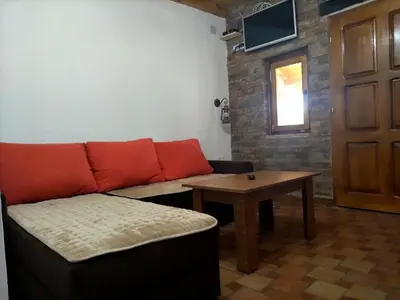 a living room with a couch and a table at Tamiški mir in Staji°evo