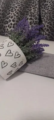 a tie with writing on it next to purple flowers at Apartment Pionir Grim in Belgrade