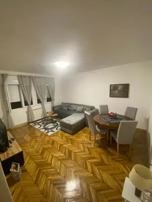 a living room with a couch and a table at Apartment Pionir Grim in Belgrade