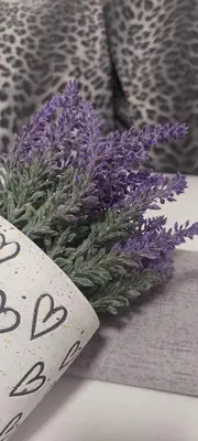 a bouquet of purple flowers sitting next to a piece of paper at Apartment Pionir Grim in Belgrade