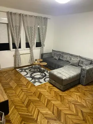 a living room with a couch and a table at Apartment Pionir Grim in Belgrade