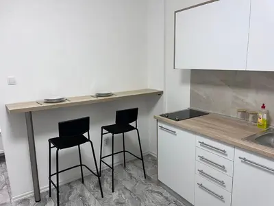 a kitchen with two bar stools and a counter at RiverScapeMoments Studio in Belgrade