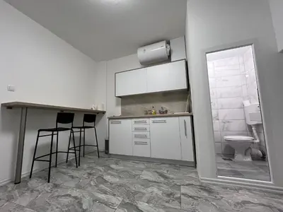 a kitchen with a sink and a toilet and a counter at RiverScapeMoments Studio in Belgrade