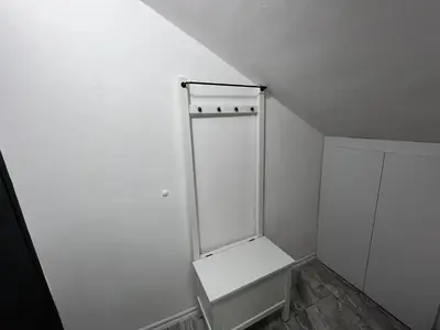 a small white closet with a shelf on the wall at RiverScapeMoments Studio in Belgrade