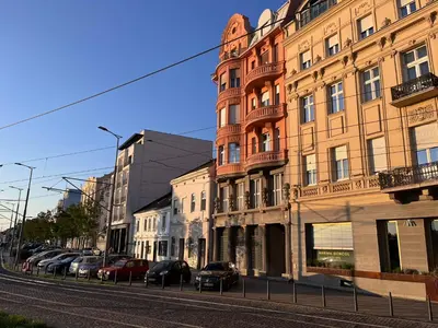 a street with buildings and cars parked on the street at RiverScapeMoments Studio in Belgrade