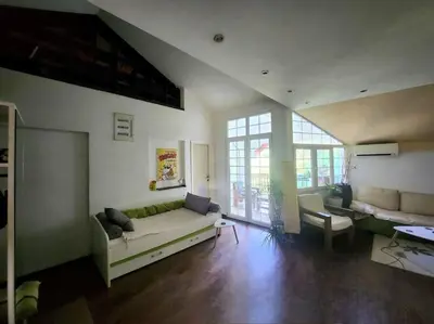 a living room with a couch and a table at Wenge in Karaburma