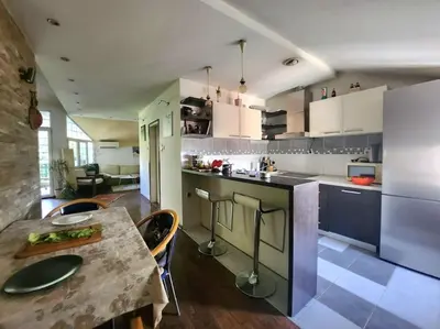 a kitchen with a table and a dining room at Wenge in Karaburma