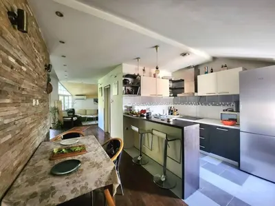 a kitchen with a table and a counter top at Wenge in Karaburma