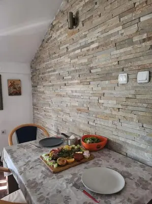 a table with a plate of food on it at Wenge in Karaburma