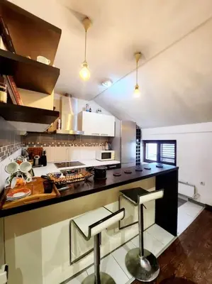 a kitchen with a counter and a stove top oven at Wenge in Karaburma