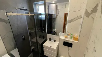 a bathroom with a shower and a sink and a mirror at Top secret 24 in Belgrade