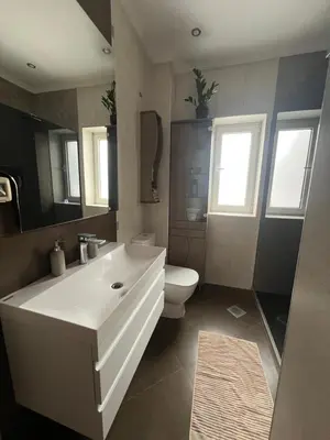 a bathroom with a white sink and a toilet at Top secret 24 in Belgrade