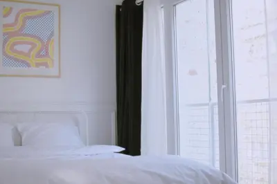 a bedroom with a white bed and a window at Tasmajdan in Belgrade
