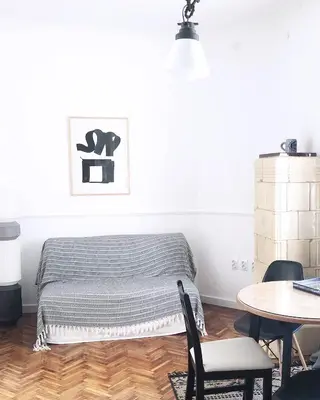 a bed in a room with a table and chairs at Tasmajdan in Belgrade
