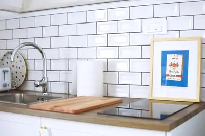 a kitchen counter with a cutting board and a sink at Tasmajdan in Belgrade