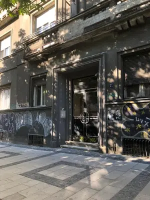 a black building with graffiti on the side of it at Tasmajdan in Belgrade