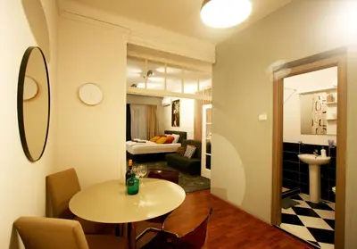 a room with a table and a living room at Apartment Moka in Belgrade