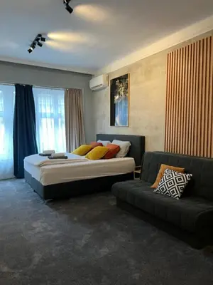 a bedroom with a large bed and a couch at Apartment Moka in Belgrade