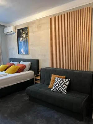 a living room with a couch and a bed at Apartment Moka in Belgrade