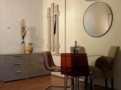 a dining room with a glass table and a mirror at Apartment Moka in Belgrade