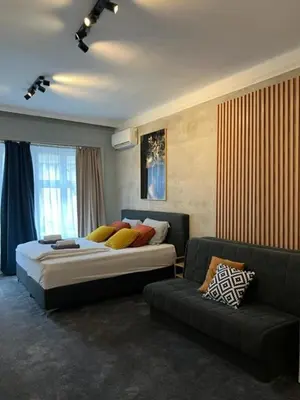 a bedroom with a bed and a couch at Apartment Moka in Belgrade