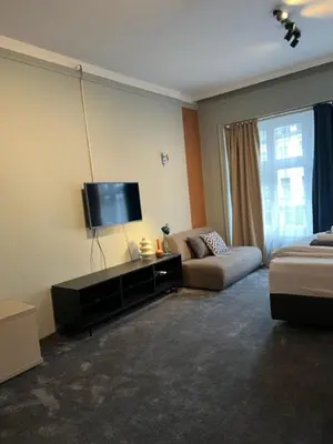 a living room with a couch and a flat screen tv at Apartment Moka in Belgrade