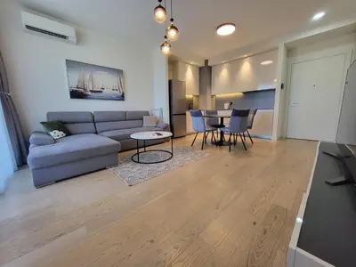 a living room with a couch and a table at BW Waterfront LUX apartment, parking free in Sajmište