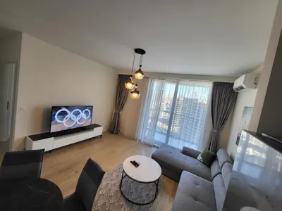 a living room with a couch and a tv at BW Waterfront LUX apartment, parking free in Sajmište