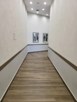 an empty hallway with white walls and wood floors at BW Waterfront LUX apartment, parking free in Sajmište