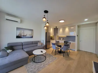 a living room with a couch and a table at BW Waterfront LUX apartment, parking free in Sajmište