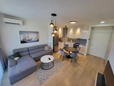 a living room with a couch and a table at BW Waterfront LUX apartment, parking free in Sajmište