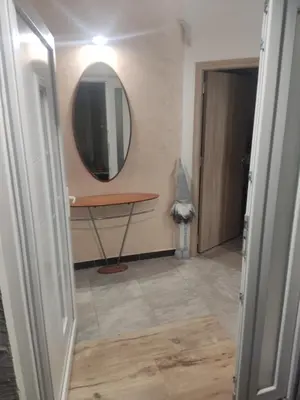 a bathroom with a mirror and a table and a door at Oaza lux in Dušanovac (historical)