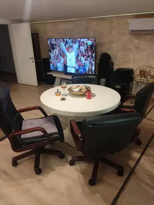 a table and chairs in a room with a tv at Oaza lux in Dušanovac (historical)