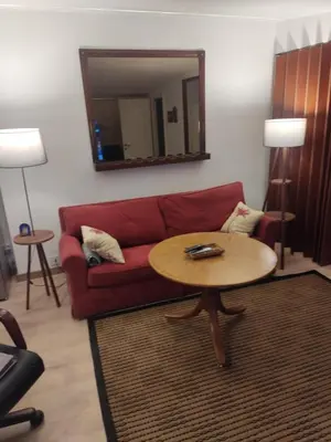 a living room with a red couch and a table at Oaza lux in Dušanovac (historical)