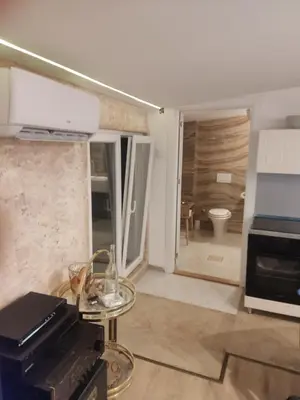 a living room with a table and a bathroom at Oaza lux in Dušanovac (historical)