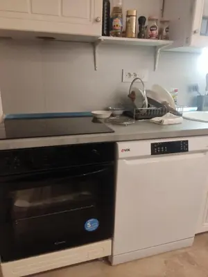 a kitchen with a black oven and a counter top at Oaza lux in Dušanovac (historical)