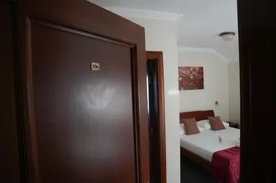 a door to a room with a bed and a bedroom at Comfort Lodge in Stari Banovci